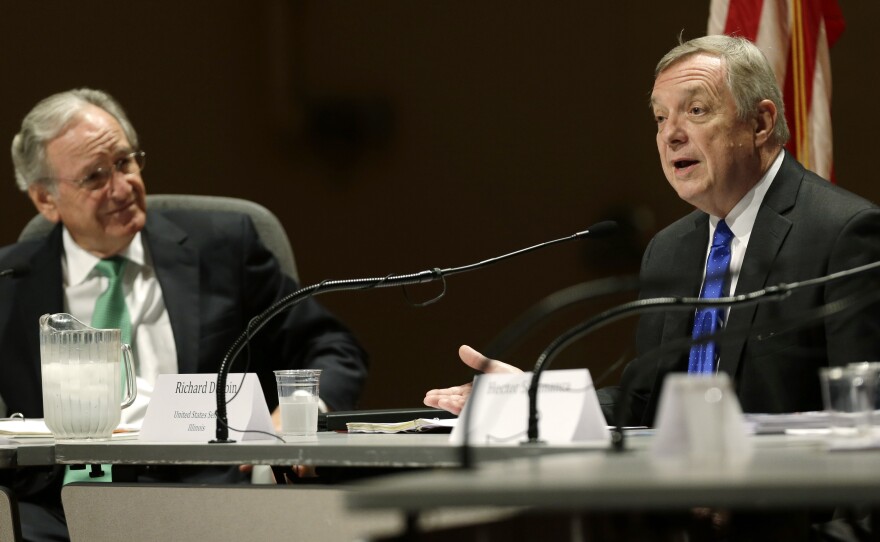 Sen. Tom Harking listens as Sen. Dick Durbin speaks at a  forum on immigration in Ames, Iowa on Friday.