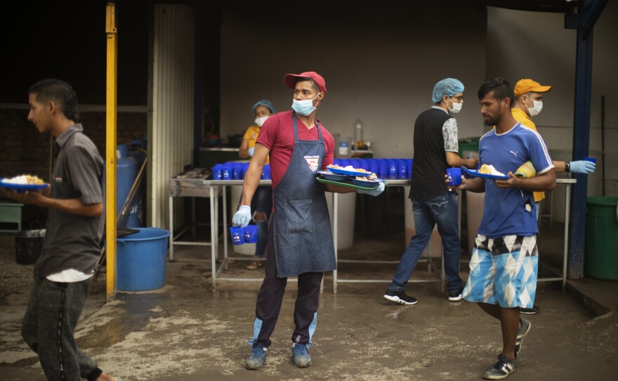 Alexis Rivero, 25, helps distribute meals at the kitchen.