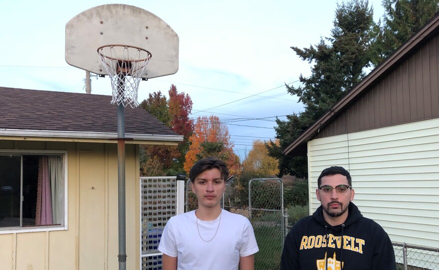 Antonio Jimenez (L) and his father Antonio Garcia at their home in Portland, Ore. Jimenez, a 16-year-old high school junior, has been trying to develop his basketball skills during the pandemic by training in small groups with other players and shooting several hundred jump shots daily at home.