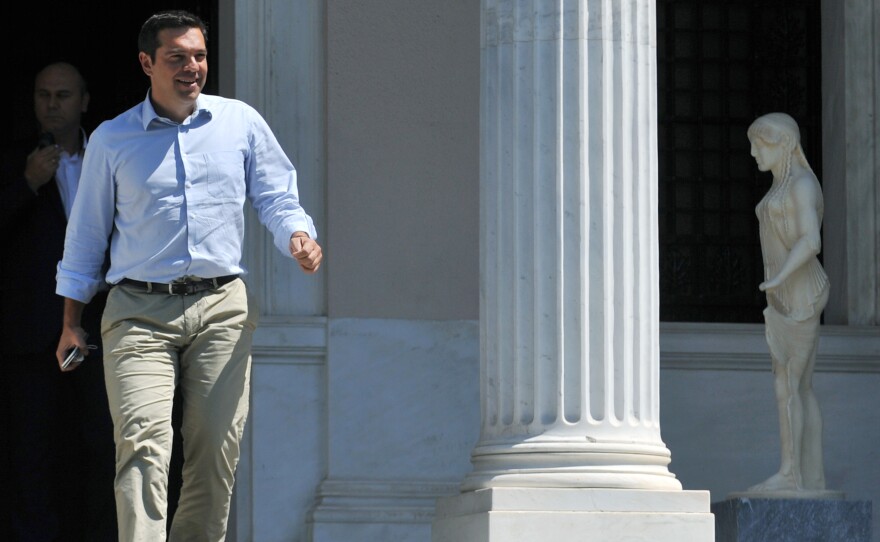 Greek Prime Minister Alexis Tsipras leaves his office in Athens, on Thursday, hours before he announced he would step down as prime minister amid fresh elections, set for Sept. 20.