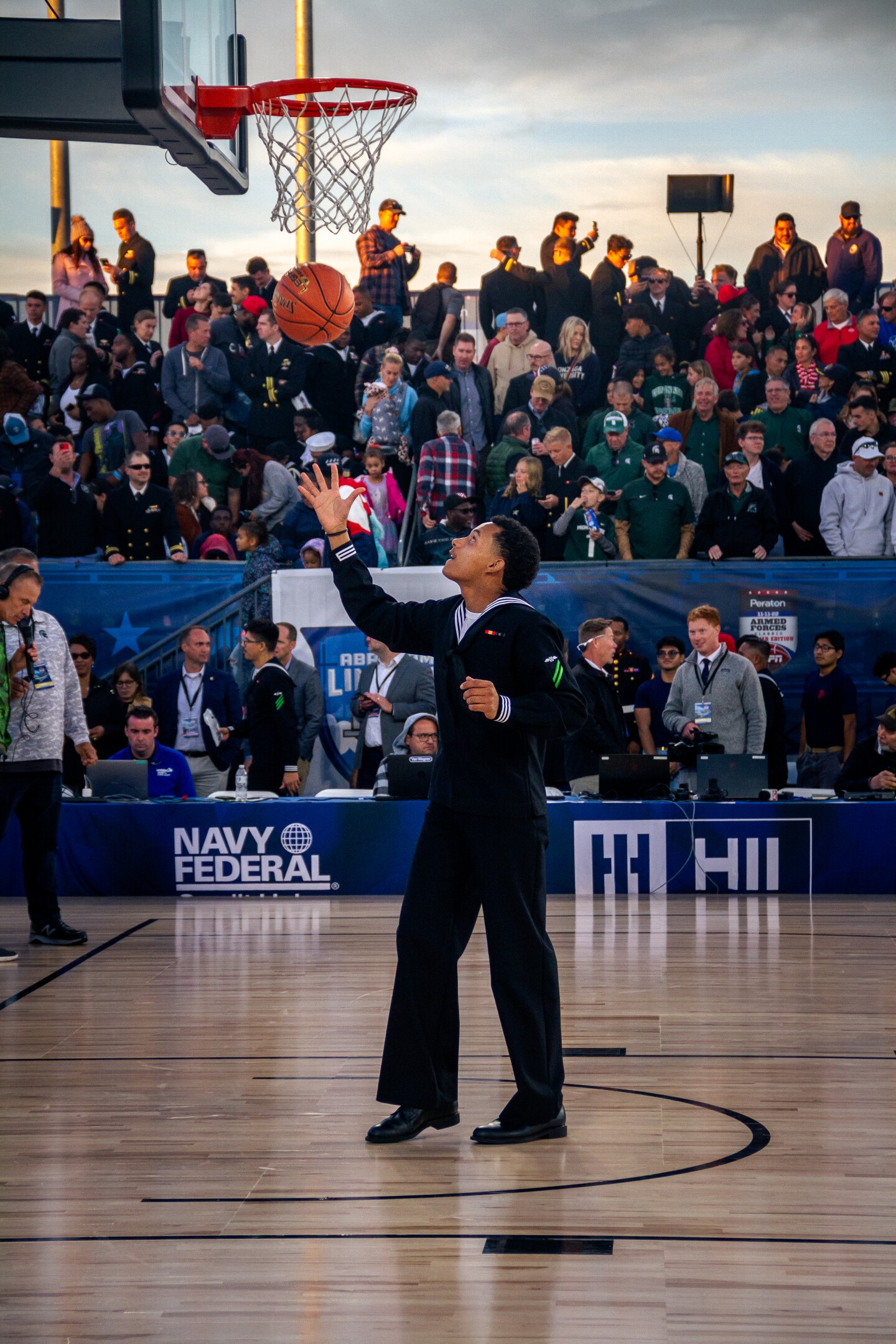 A Navy sailor goes for a lay up before the start of the Armed Forces Class on the USS Abraham Lincoln on Nov. 11, 2022.