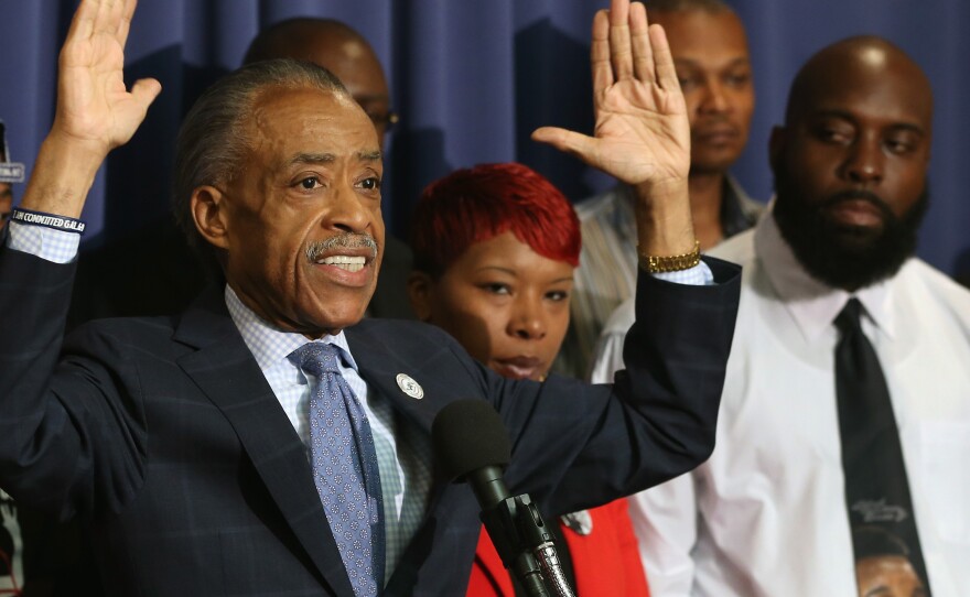 The Rev. Al Sharpton called Thursday for a federal review of racial violence and discrimination in the law enforcement community. He is flanked at the National Press Club in Washington by Lesley McSpadden and Michael Brown Sr., parents of Michael Brown who was killed by police in Ferguson, Mo.