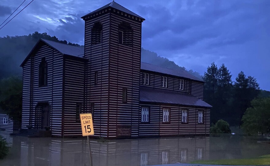 This image provided by Marlene Abner Stokely shows flooding by the Buckhorn Log Cathedral on Thursday in Buckhorn, Ky.
