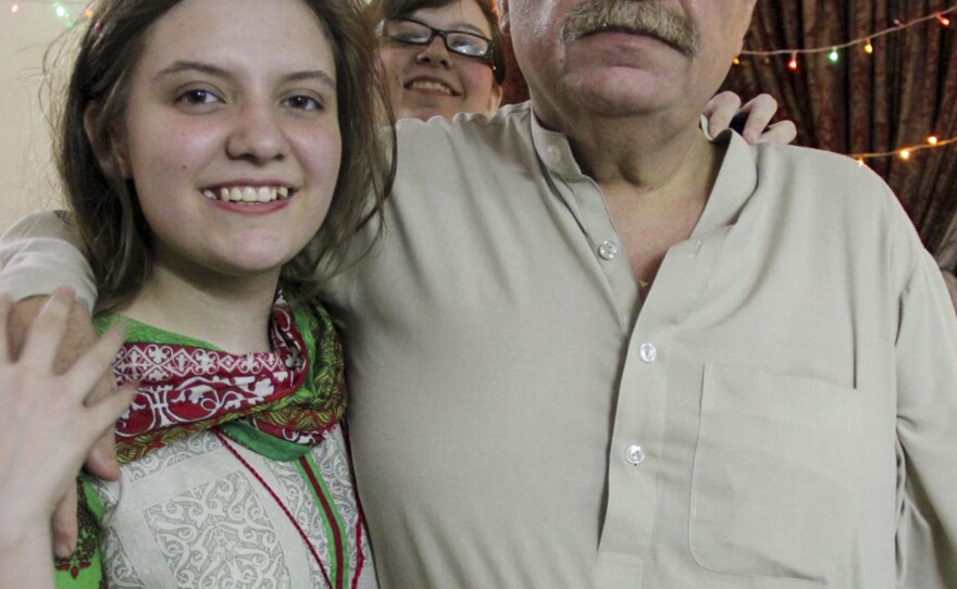 Idris Khattak disappeared in November. He is pictured with daughters Talia Khan and Shumaisa (in the background), on July 29, 2015, in Islamabad.