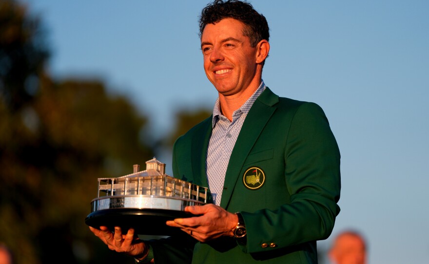 Rory McIlroy, of Northern Ireland, holds the trophy after winning the Masters golf tournament at the Augusta National Golf Club, Sunday, April 12, 2026, in Augusta, Ga.