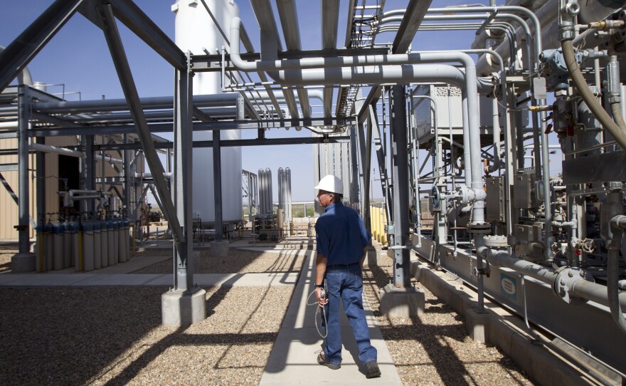 Deward Cawthon, a plant operator at the Federal Helium Reserve, walks through the Federal Crude Helium Enrichment Unit near Amarillo, Texas, in 2011.