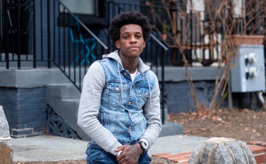 Fred Brown in front of his family's former home in the Columbia Heights neighborhood of Washington, D.C.