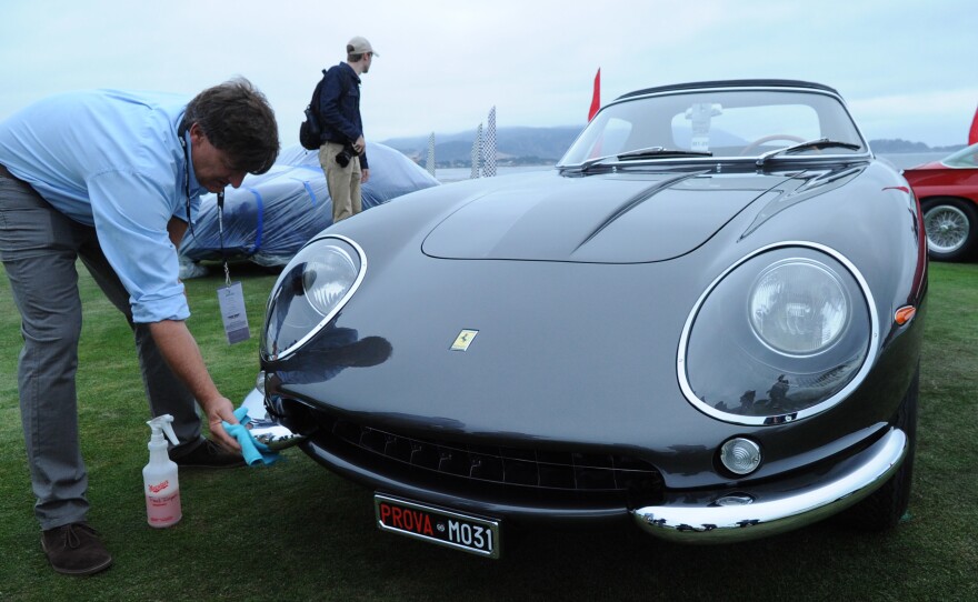 Dan Schaefer does a last-minute detail before judging on the 1968 Ferrari 275 GTS/4 Scaglietti NART Spider owned by Chris and Ann Cox, Chapel Hill, N.C. Just 10 examples of this car were built and this is tenth one.