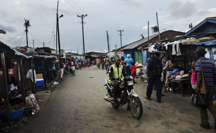 A motorbike rider drives along the main route through West Point.
