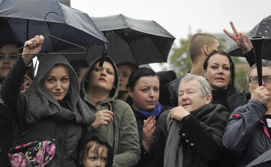 Massive protests were held in the rain in the streets of Warsaw, Gdansk, Wroclaw and elsewhere across the largely Catholic nation of Poland, as the conservative-controlled legislature considers an absolute ban on abortion. Here, women in Warsaw hold up a coat hanger, a symbol of dangerous and illegal abortions.