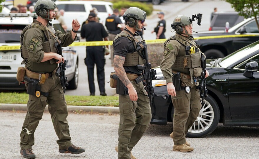 Authorities stage outside Columbiana Centre mall in Columbia, S.C., following a shooting on Saturday.