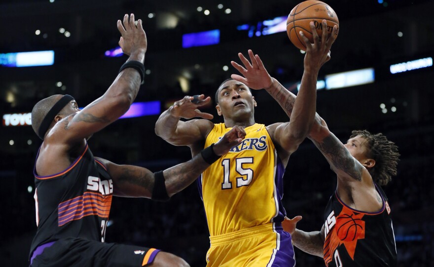 The Los Angeles Lakers' Metta World Peace (center), formerly known as Ron Artest, has been suspended 12 times for displays of violence during his career. Here, he is fouled during a recent game against the Phoenix Suns.