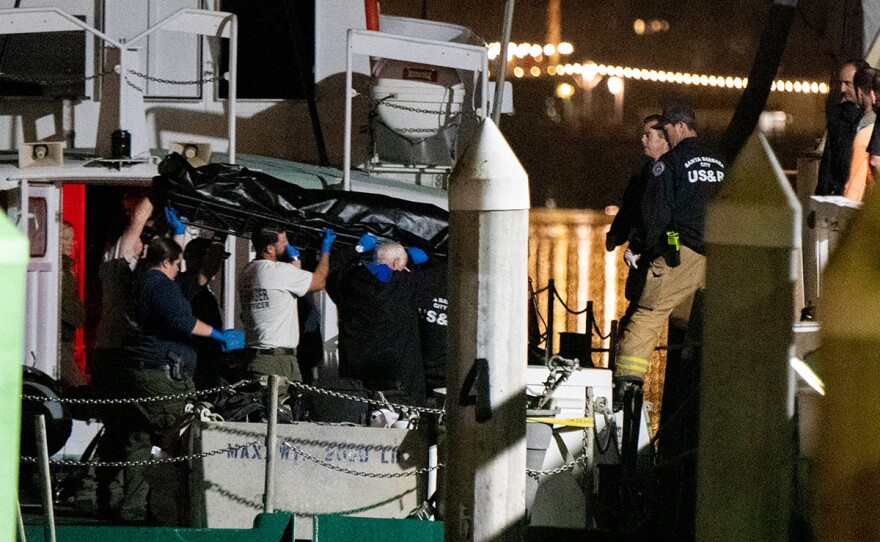 Local law enforcement along with search and rescue teams help unload the bodies of those who died in a diving boat fire, Monday, Sept. 2, 2019, in Santa Barbara, Calif. A fire raged through a boat carrying recreational scuba divers anchored near an island off the Southern California coast early Monday, leaving multiple people dead and hope diminishing that any of the remaining people still missing would be found alive.