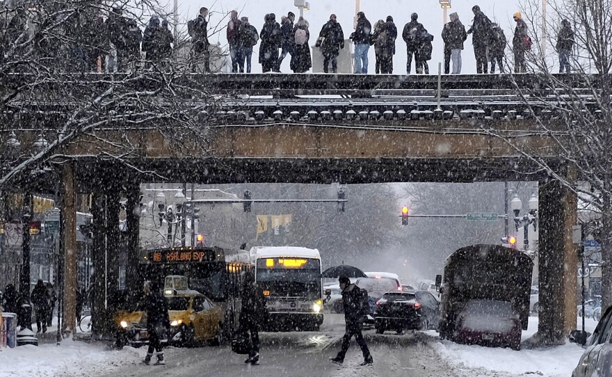 Commuters wait for a train as snow falls in Chicago. With a polar vortex hitting the Midwest, wind chills could dip to 55 degrees below zero in northern Illinois.
