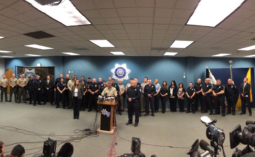 Sheriff John McMahon introduces first responders at a news conference.