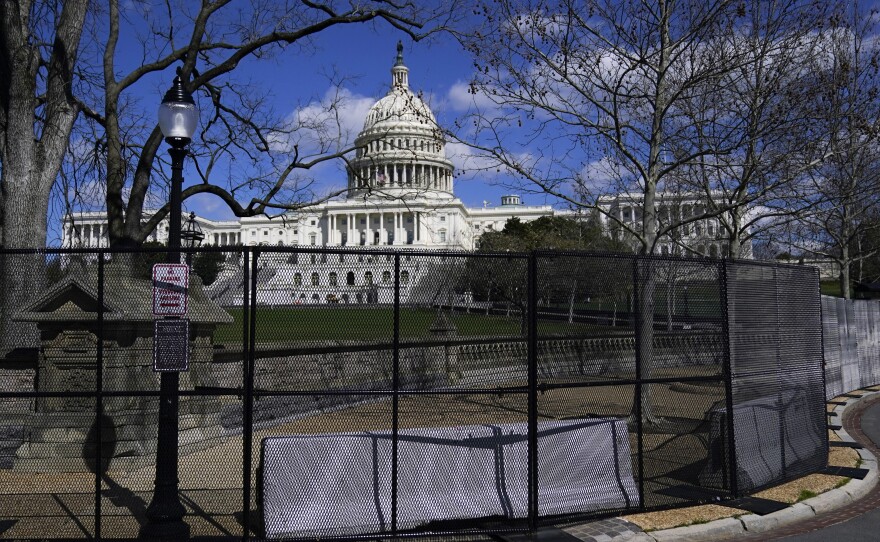 In this April 2, 2021, file photo the U.S. Capitol is seen behind security fencing on Capitol Hill in Washington.