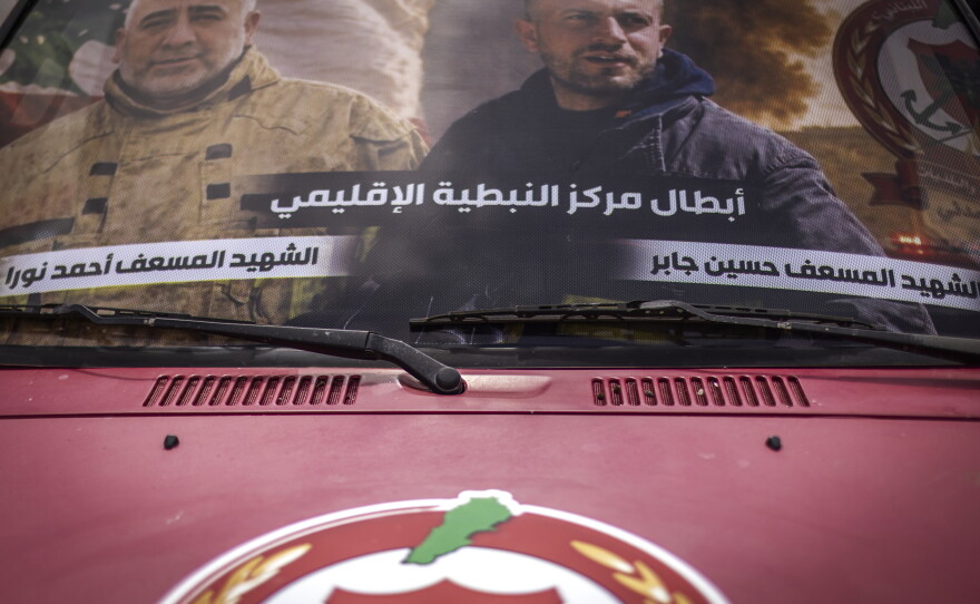 Pictures of Lebanese Civil Defense members Hussein Jaber and Ahmad Noura, who were killed in an Israeli strike on the southern town of Nabatieh, are displayed on an ambulance in Nabatiyeh on May 13.