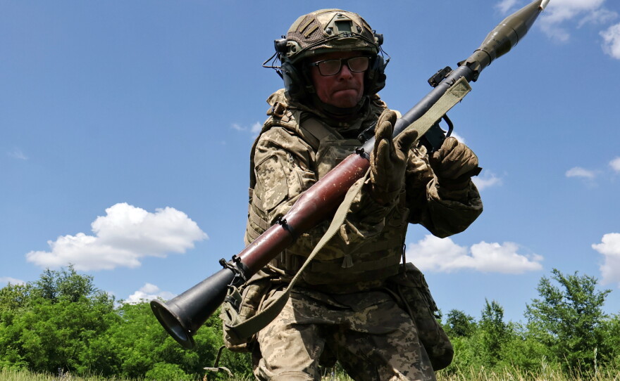 In this photo provided by Ukraine's 65th Mechanized Brigade press service, a soldier practices military skills at a training ground near the frontline in the Zaporizhzhia region, Ukraine, Saturday, June 20, 2026.