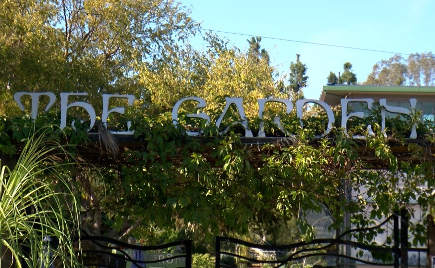 A sign that says 'The Garden' above the front gate is shown on November 19, 2024.
