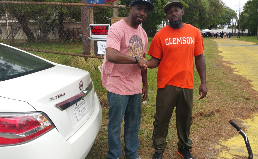 The author (left) and North Charleston resident Nathaniel Grant Junior — who happened to be wearing a Clemson tee—at the site of Walter Scott's killing.