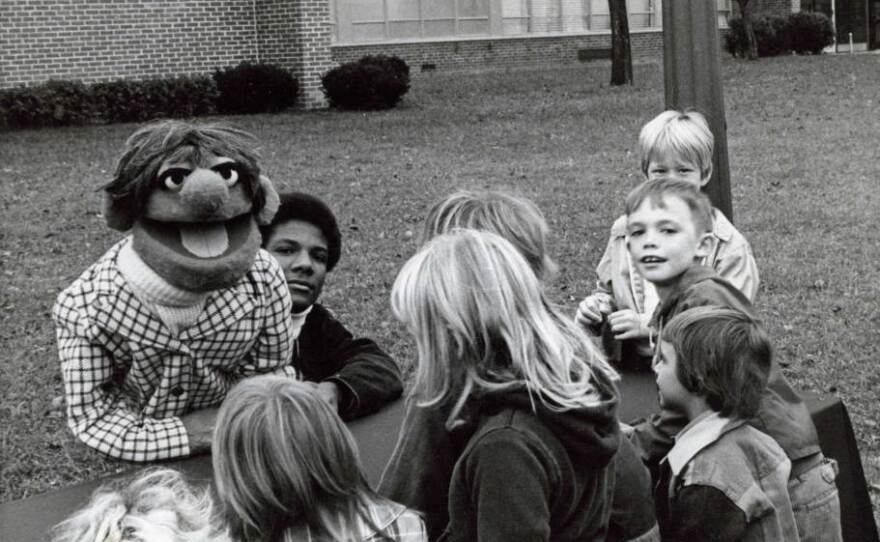 Kevin Clash (center) started making puppets when he was a teenager in Baltimore.