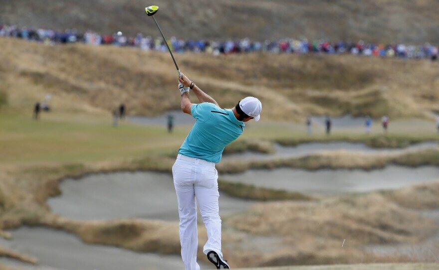 Rory McIlroy, of Northern Ireland, watches his tee shot on the fourth hole during the first round of the U.S. Open at Chambers Bay.