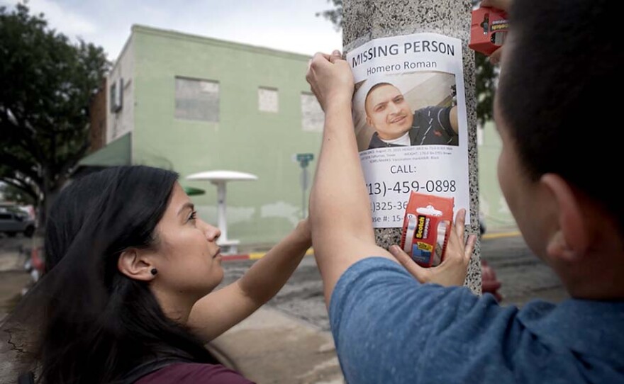 Omar Roman and his wife Michelle post missing person notices on the streets of Falfurrias in Brooks County, Texas.