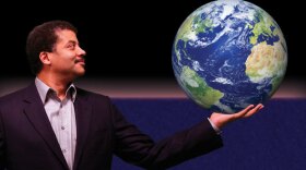 Promotional photo of renowned astrophysicist Neil deGrasse Tyson, host of "NOVA scienceNOW" with the Earth in his hands