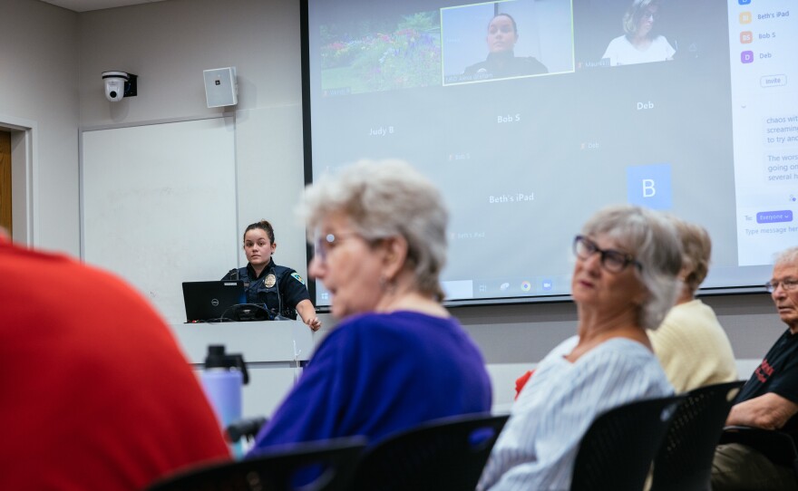 Neighborhood resource officer Alexa Graham takes questions during a "Coffee with a Cop" event at Pinney Library on July 18, 2022 in Madison, Wis.