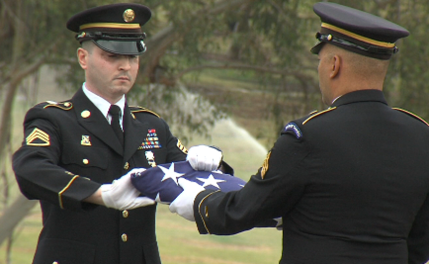 Rida Sihab Mansour folding the flag, as part of his Honor Guard duties at a military funeral at Greenwood Memorial Park, March 11, 2015.