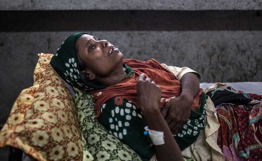 Morzina, a 40-year-old Rohingya refugee from Tangbazar, Myanmar, winces in pain at the Sadar Hospital in the Bangladeshi town of Cox's Bazar. Soldiers from Myanmar's army smashed her in the ribs with a rifle butt as they raided her home in early September.