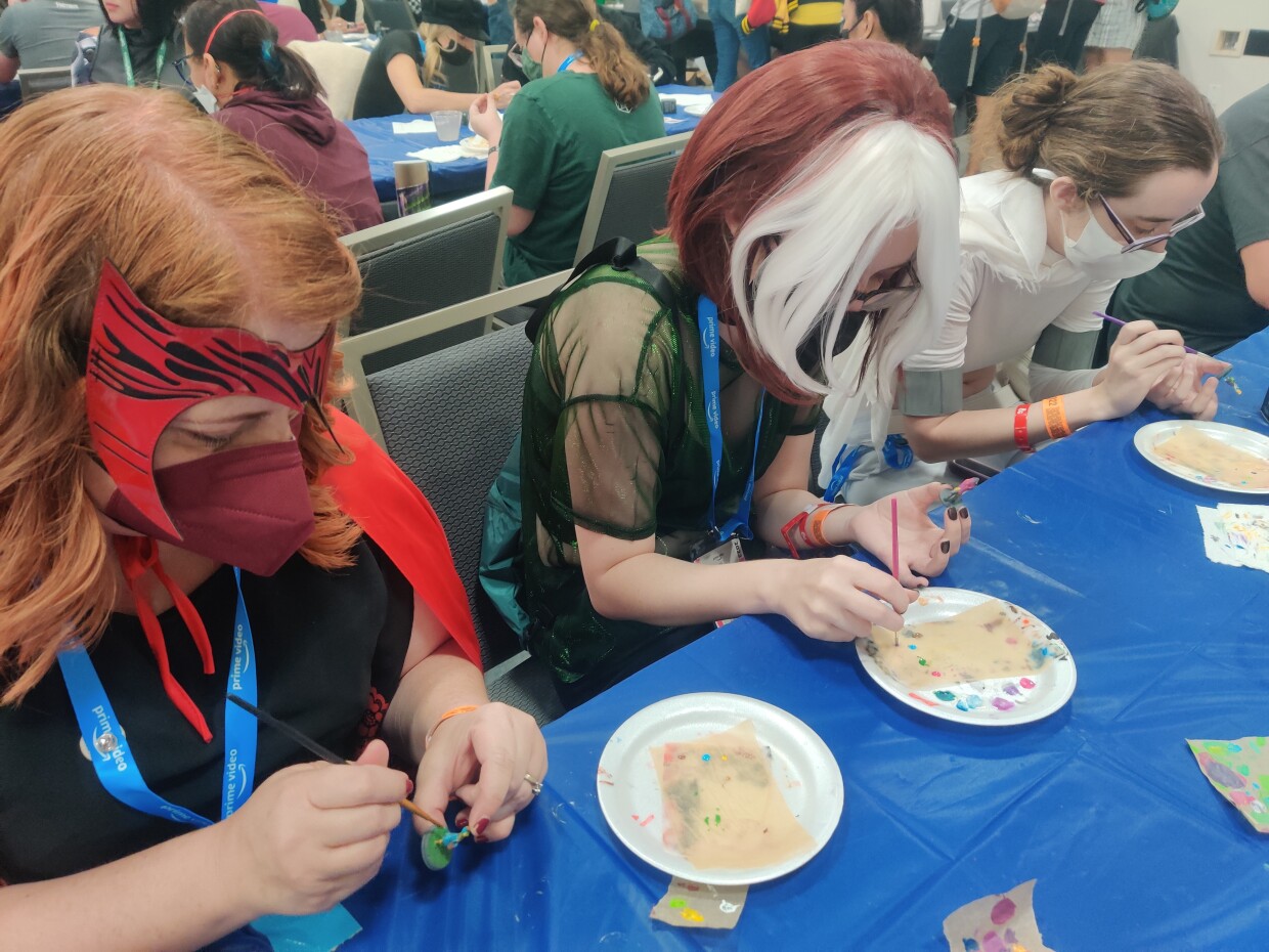 Amber, Carter and Kenzie Lappin create RPG figurines at Comic-Con, July 24, 2022. 