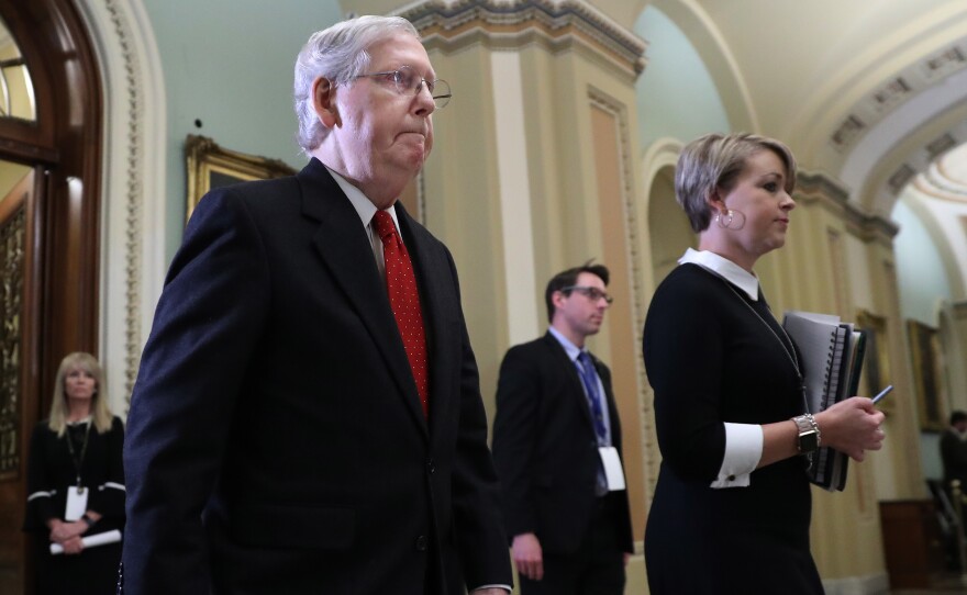 Senate Majority Leader Mitch McConnell, R-Ky., walks out of the Senate Chamber before the start of President Trump's impeachment trial on Tuesday.