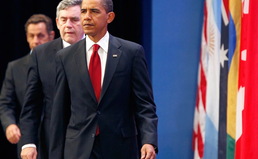 President Obama, followed by British Prime Minister Gordon Brown (center) and French President Nicolas Sarkozy, arrives to make a statement on Iran's nuclear facility Friday during the G-20 Summit in Pittsburgh.