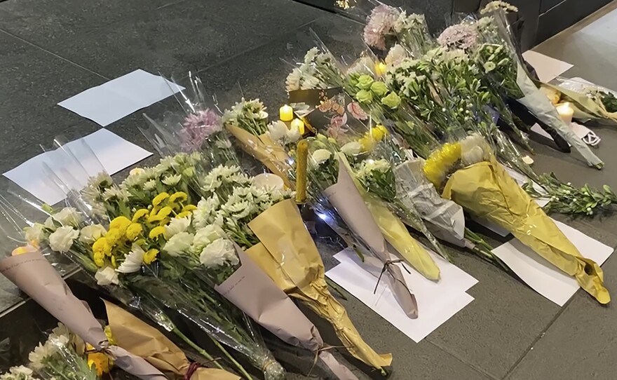 Blank white papers and flowers are laid down during a commemoration for victims of a recent Urumqi deadly fire in Central in Hong Kong, Monday, Nov. 28, 2022.