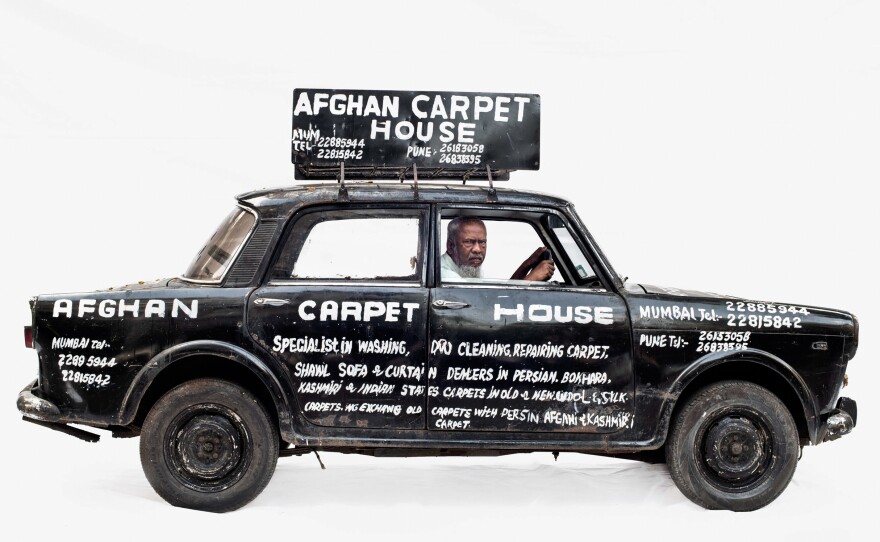 From the 'Homo Mobilis' project.  The photo was made on a large white backdrop. Several images in this project had digital corrections, mostly in the white backdrop. In Homo Mobilis Martin Roemers explores the relation between people and their vehicles.  What does a car or other vehicle tell us about culture, society and identity?