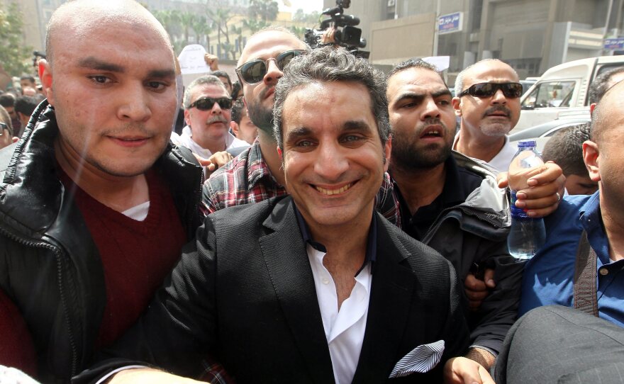 Egypt's popular TV satirist Bassem Youssef is surrounded by media and activists as he arrives at the high court in Cairo, Egypt, on March 31.
