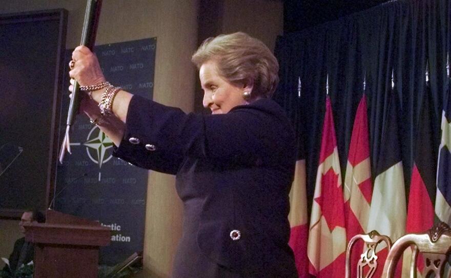 Secretary of State Madeleine Albright displays the instruments of accession that brought Hungary, Poland and the Czech Republic into NATO.