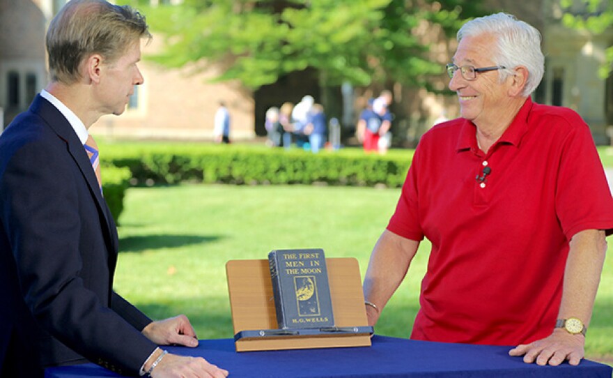 Francis J. Wahlgren (left) appraises a Neil Armstrong-signed "The First Men in the Moon" at Meadow Brook Hall in Rochester, Mich.