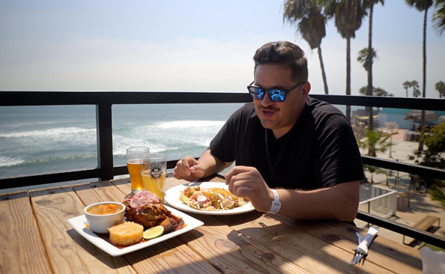 Host Jorge Meraz tastes beer and the food at Sin Fronteras Brewing, at K38 to the south of Rosarito, Mexico.