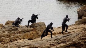 U.S. Navy SEALs practice Over The Beach evolutions during a training exercise in a Remote Training Facility.