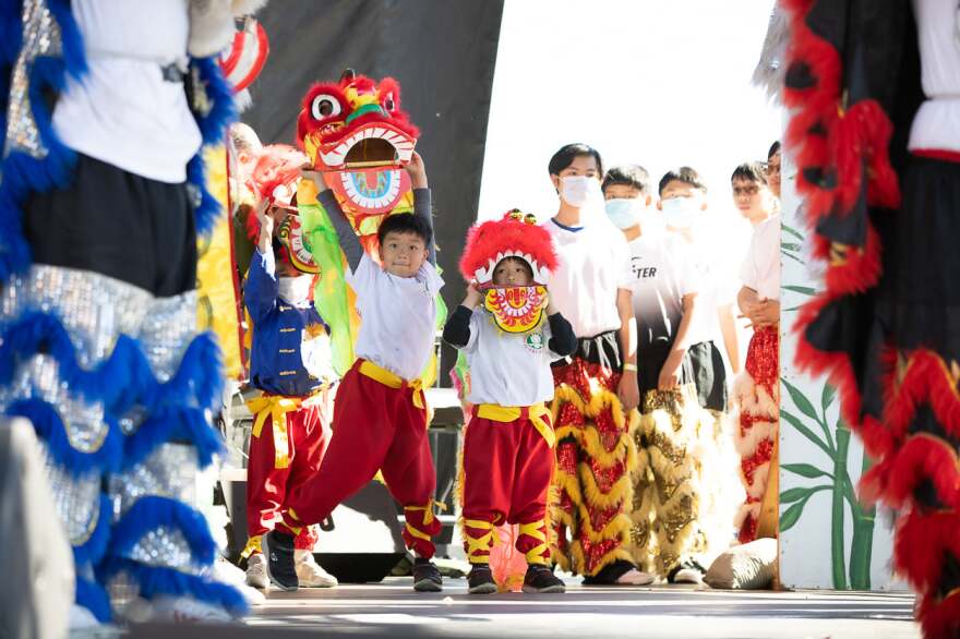 Tiny lion dancers from the Hoa Nghien Lion Dance troupe getting ready to perform on stage at the San Diego Tet Festival in Mira Mesa Community Park, Feb. 5, 2022.