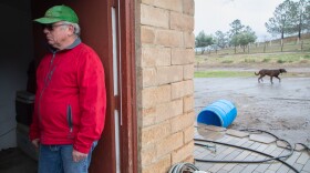 Nathan Rakov finds shelter during a rainstorm on his ranch in Alpine on Jan. 29, 2021.