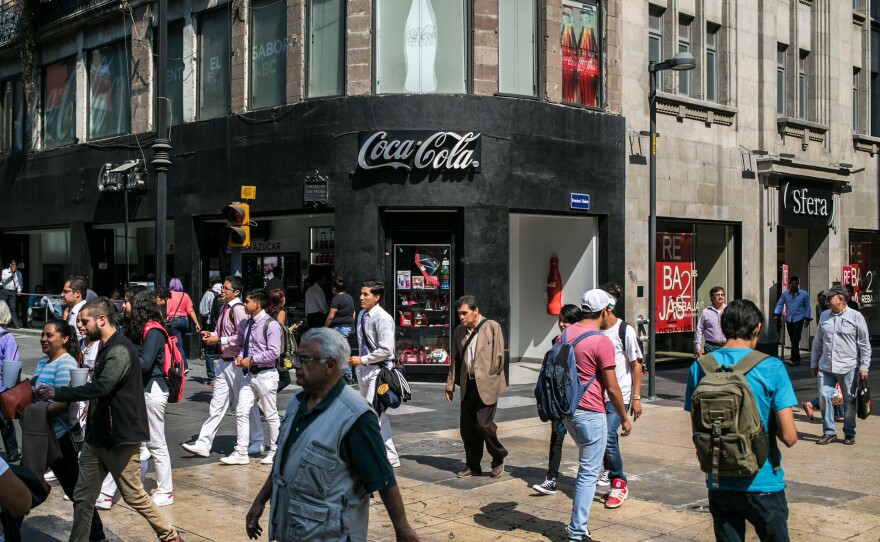 Crowds pass a Coca-Cola store in Mexico City's Centro Historico district. In 2015, the average Mexican drank nearly two glasses of Coke a day.