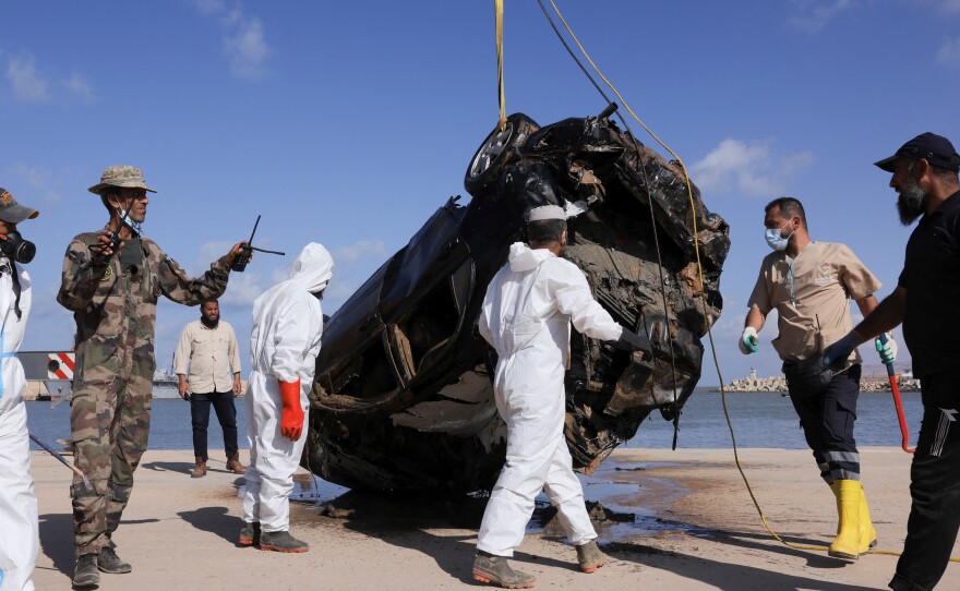 Field Medicine and Support Center workers handle a vehicle recovered from the sea after it was swept away during floods in Derna, Sept. 20.