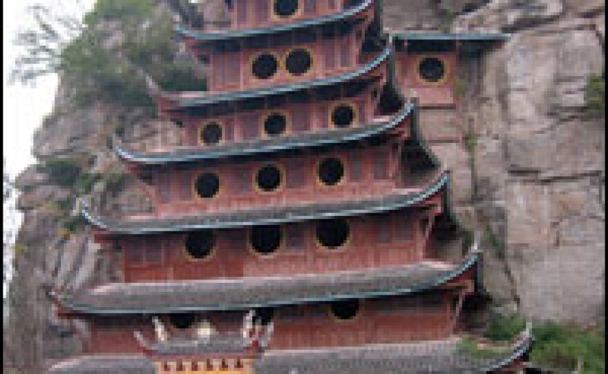 The Stone Treasure Fortress includes a Taoist temple and a fortified stockade overlooking an ancient town that has been demolished ahead of the rising waters.