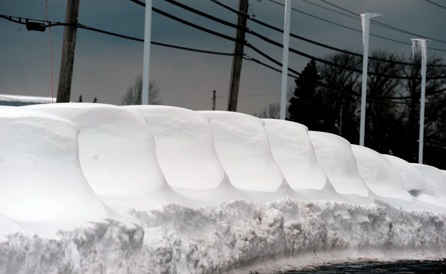 New cars are shown buried under snow after an intense lake-effect snowstorm impacted the area on Saturday in Hamburg, New York.