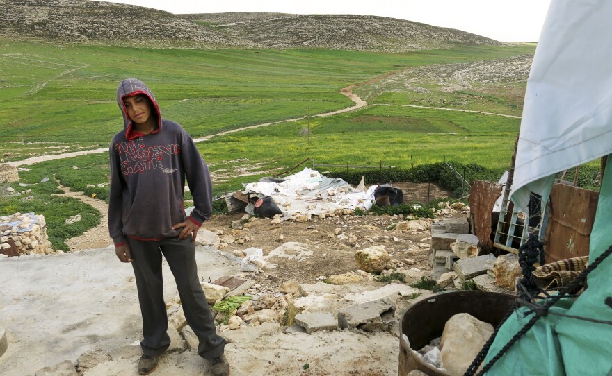 Majid Banifadel, 16, stands in the remains of his family home.