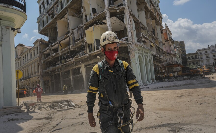 A rescue worker walks away from the destroyed five-star Hotel Saratoga on Tuesday after searching through the rubble days after a deadly explosion in Old Havana, Cuba.