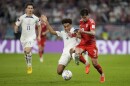 Tyler Adams of the United States, and Wales' Ben Davies vie for the ball during the World Cup, group B soccer match between the United States and Wales, at the Ahmad Bin Ali Stadium in in Doha, Qatar, Monday, Nov. 21, 2022.